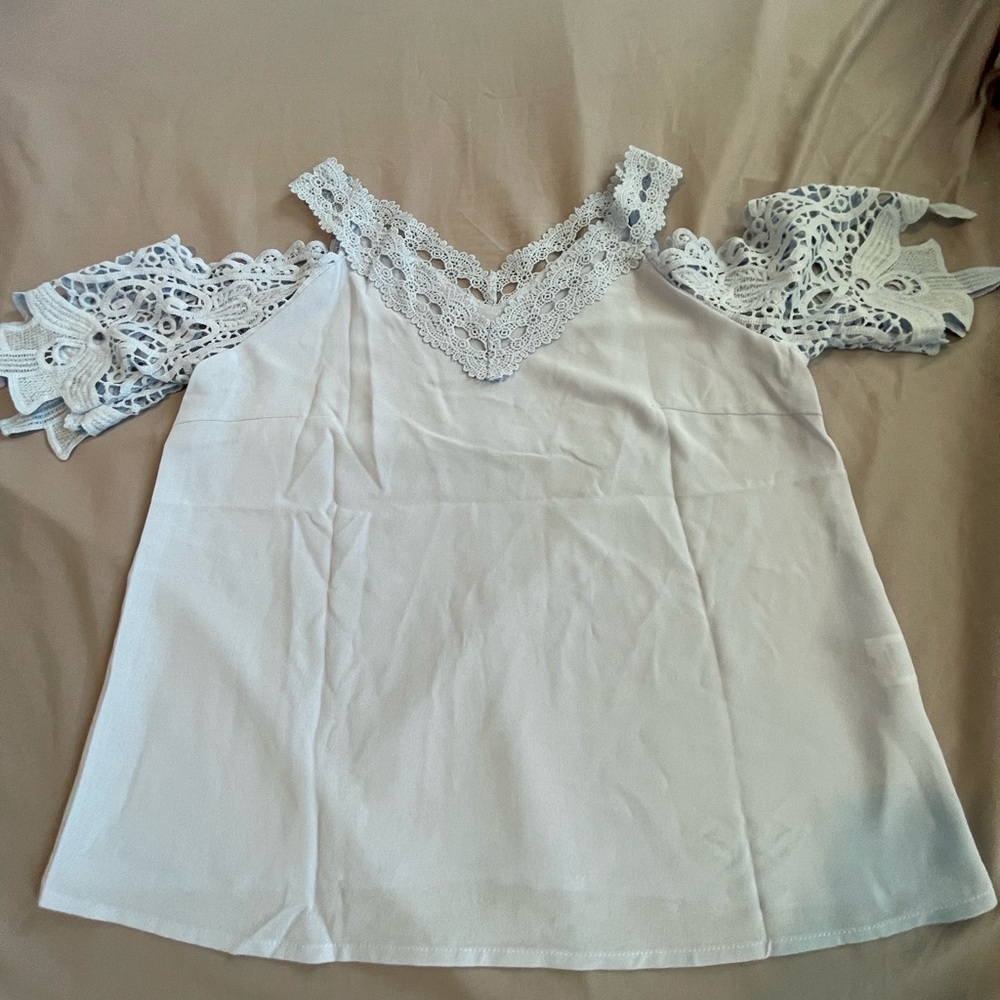 A women’s large blue shirt from shein, flowered neck line and sleeves
